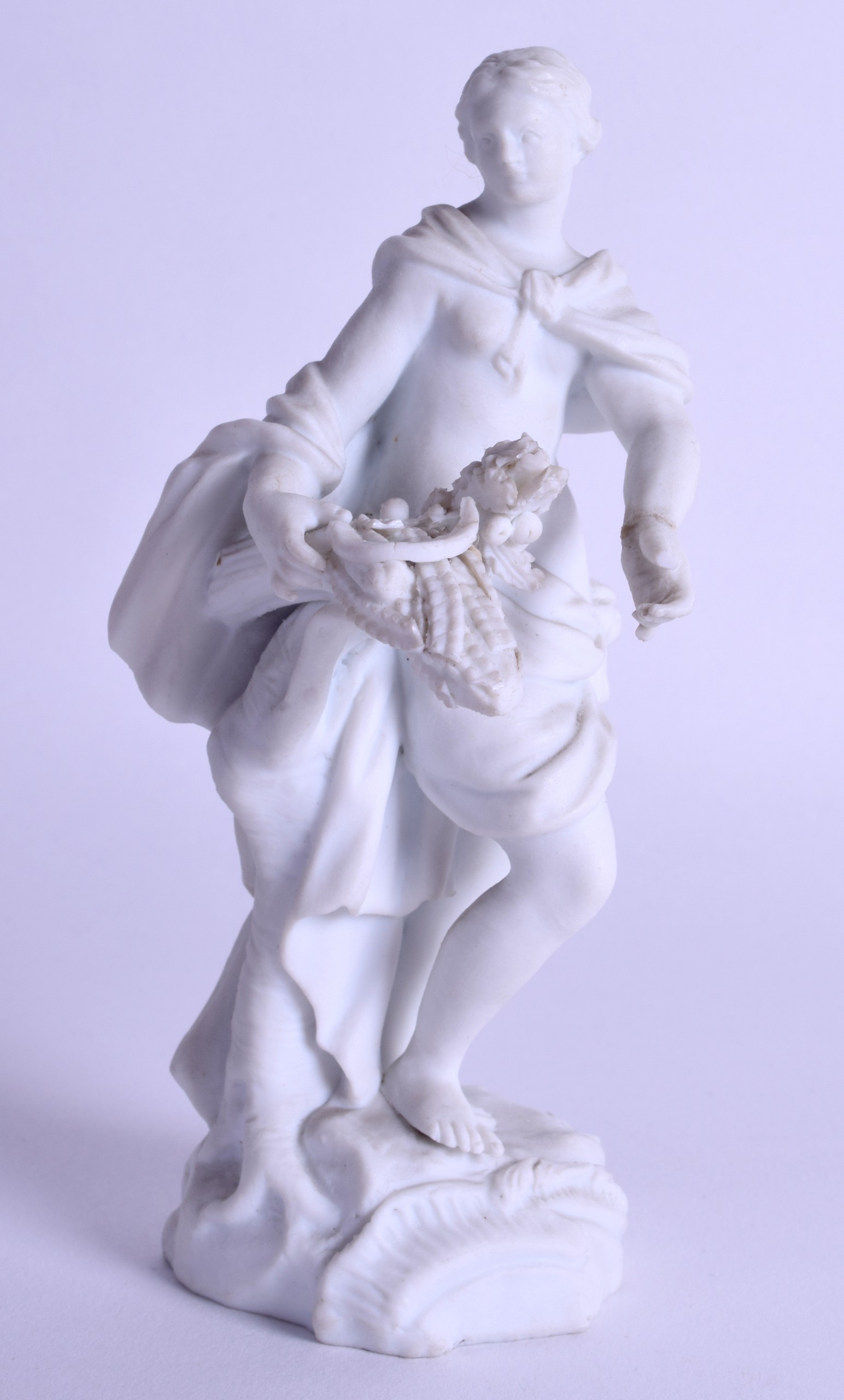 18th c. Meissen biscuit figure of woman in a flowing robe holding corn and a scythe standing on a