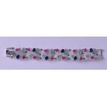 A SILVER RUBY EMERALD AND SAPPHIRE COCKTAIL BRACELET. 19 cm long.