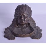 A LATE 19TH CENTURY NATIVE AMERICAN BRONZE INKWELL with rising head and feather work head dress.