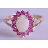 A 9CT GOLD OPAL AND RUBY RING. Size O.