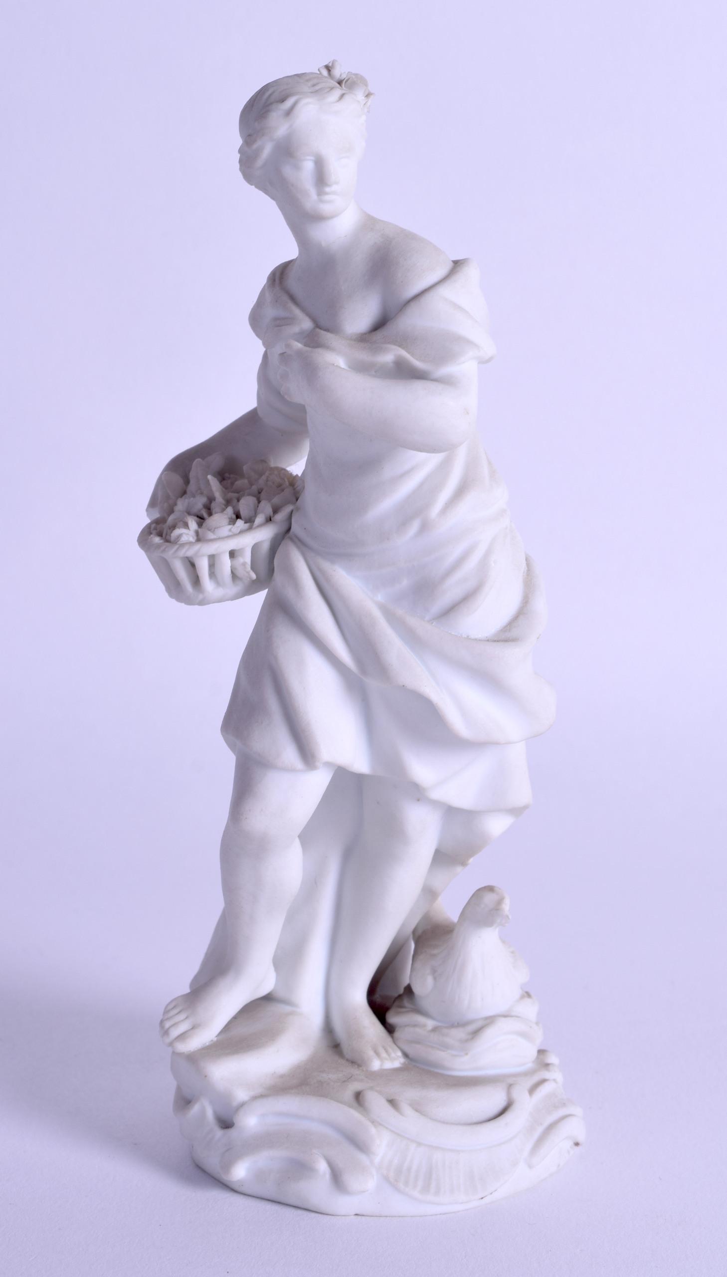 18th c. Meissen biscuit figure of woman in a flowing robe holding flowers in a basket standing on