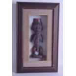 AN UNUSUAL EARLY 20TH CENTURY AFRICAN TRIBAL HARDWOOD FERTILITY FIGURE encased within a fitted glass