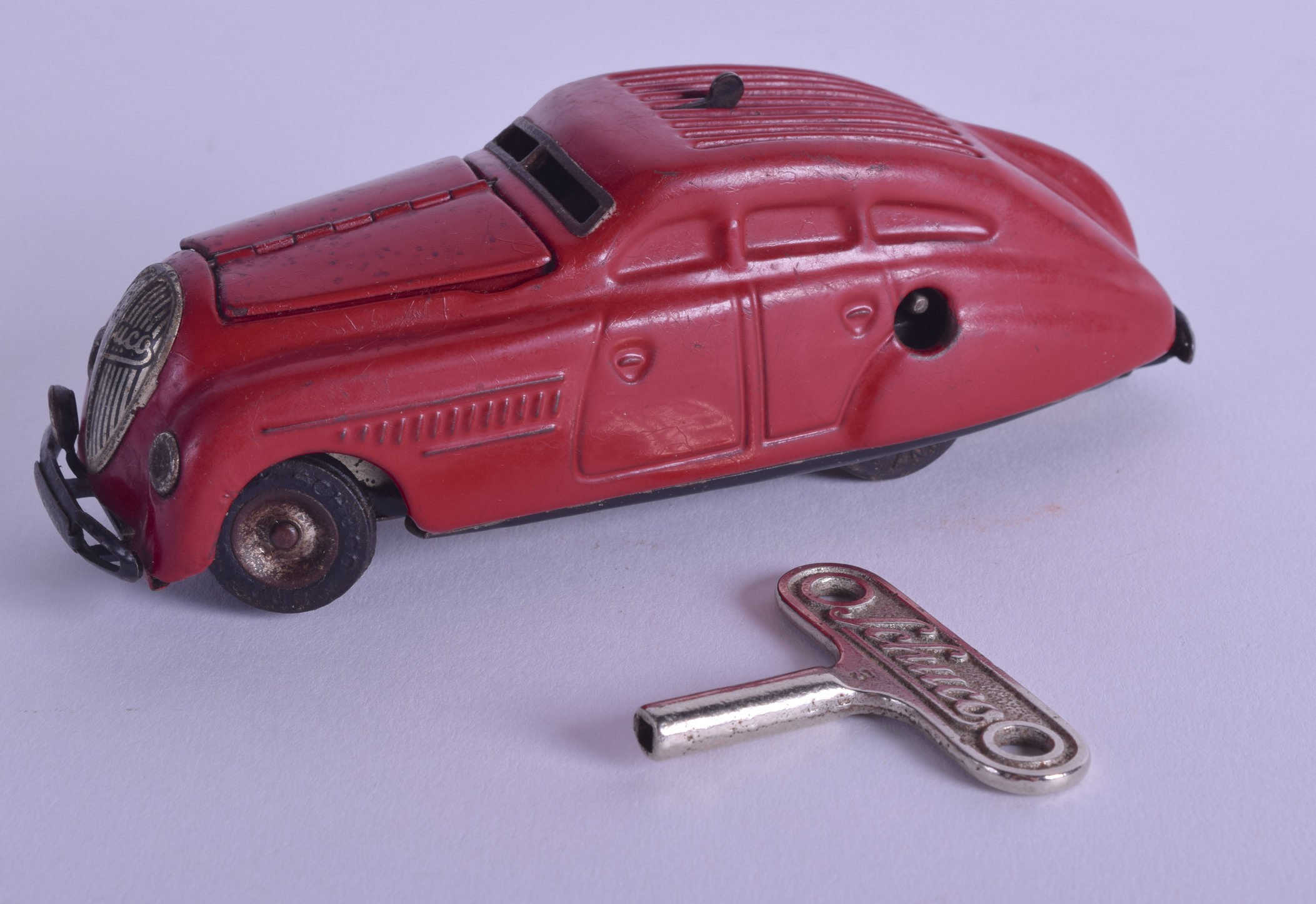 A RARE SCHUCO 'BLOW START' KOMMANDO ANNO 2000 WIND UP CAR. 14 cm long.