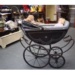 A GOOD VICTORIAN DOLL'S PRAM CIRCA 1850, with porcelain handle,together with two dolls. Pram 85 cm