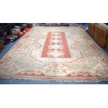 A VERY LARGE TURKISH MILAS RUG WITH MUTED COLOURS, with floral inspired decoration. 470 cm x 352