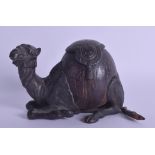 A RARE 19TH CENTURY CONTINENTAL BRONZE AND CARVED COCONUT INKWELL in the form of a recumbent