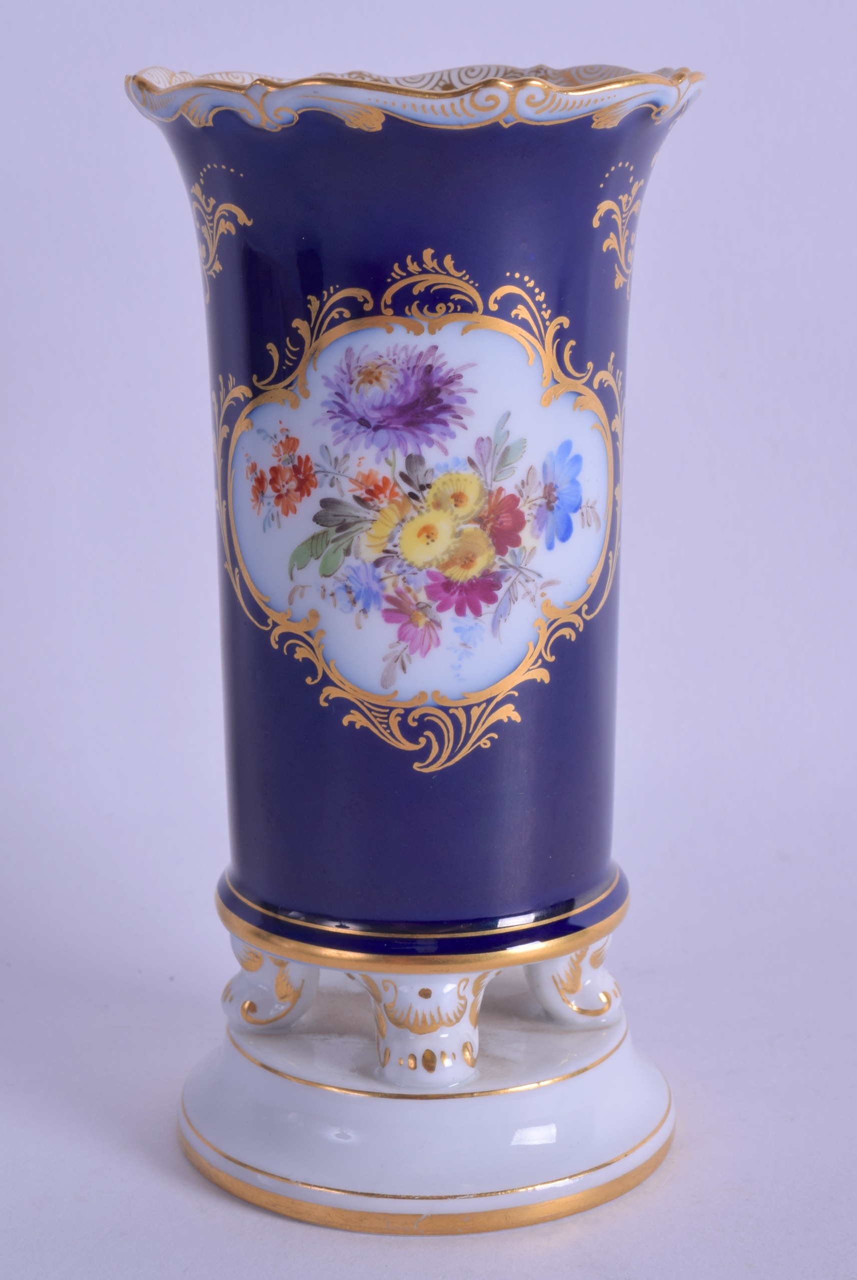 A LATE 19TH CENTURY MEISSEN PORCELAIN SPILL VASE painted with flowers upon a blue ground. 14 cm