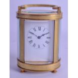 A FRENCH OVAL CARRIAGE CLOCK with white enamel dial and black numerals. 14 cm high inc handle.