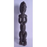 A LARGE AFRICAN CARVED TRIBAL WOOD FERTILITY FIGURE depicting a female with her hands upon her