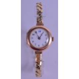 A 1930S 9CT YELLOW GOLD LADIES WRISTWATCH with yellow metal strap. 2.5 cm diameter.