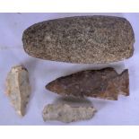 AN EARLY MAORI AXE HEAD, together with three flint arrow tips. (4)