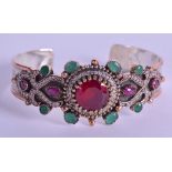 A SILVER RUBY AND CHALCEDONY BANGLE. 7 cm wide.