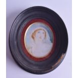 A 19TH CENTURY PAINTED IVORY PORTRAIT MINIATURE depicting a female wearing a white head dress. Image