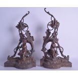 A PAIR OF 19TH CENTURY FRENCH SPELTER FIRE SIDE FIGURES modelled as young children seated upon