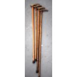 A GROUP OF FOUR HORN HANDLED WALKING CANES, possibly rhinoceros horn. Longest 91 cm. (4)