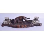 A LATE 19TH CENTURY BAVARIAN BLACK FOREST CARVED INKWELL modelled with a hound drinking water from a