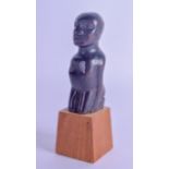 AN UNUSUAL EARLY 20TH CENTURY AFRICAN TRIBAL CARVED WOOD FIGURE unusually modelled kneeling.