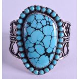 A LARGE SILVER AN TURQUOISE BANGLE with bead work banding. Central stone 3.5 cm x 6.25 cm.