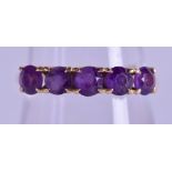 AN EDWARDIAN YELLOW GOLD FIVE STONE AMETHYST RING. Size P/Q.