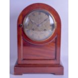 A MID 19TH CENTURY MAHOGANY MANTEL CLOCK with arched top and circular engraved dial. 34 cm x 23.5