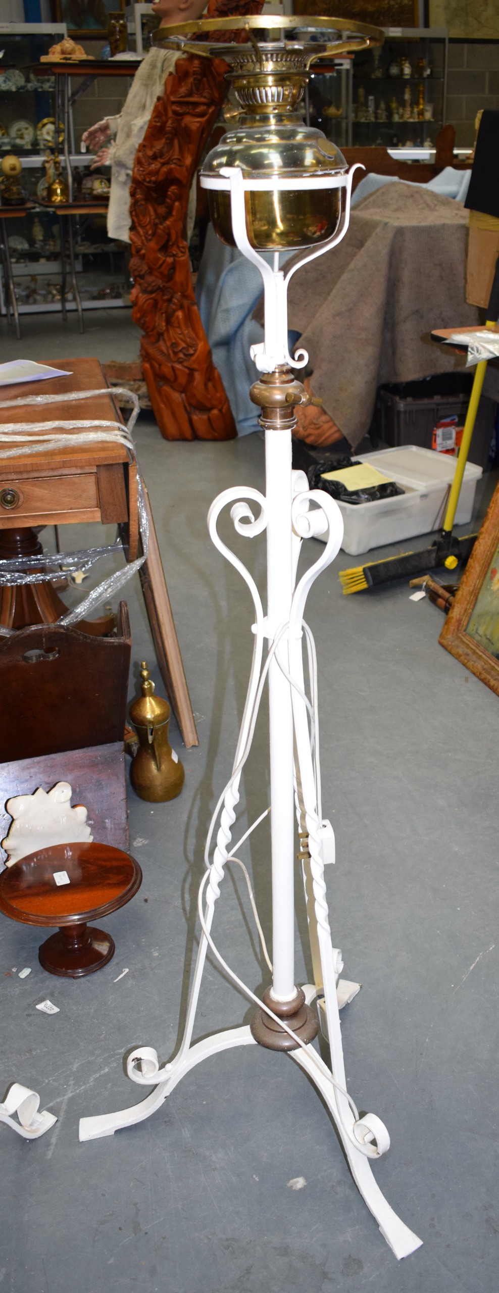 AN ANTIQUE WROUGHT IRON STANDARD OIL LAMP, painted white with twist fittings. 140 cm high.