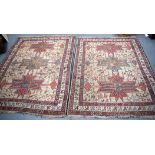 TWO BEIGE GROUND RUGS, decorated with birds and motifs. Largest 157 cm x 120 cm.