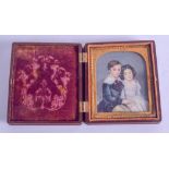 A MID 19TH CENTURY ENGLISH PAINTED IVORY PORTRAIT MINIATURE depicting a young boy and girl within an