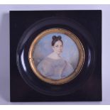 AN EARLY 19TH CENTURY PAINTED IVORY PORTRAIT MINIATURE depicting a female wearing a ballooning gown.
