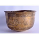 AN EARLY ISLAMIC MIDDLE EASTERN BRASS BOWL engraved with extensive foliage trailing vines and