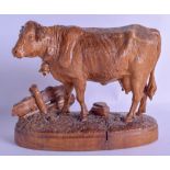 A 19TH CENTURY BAVARIAN BLACK FOREST CARVED FIGURE OF A STANDING COW modelled upon a naturalistic