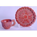 A RARE EARLY ETRUSCAN OR ROMAN RED POTTERY TEACUP AND SAUCER Antiquity, with polychrome remnants,