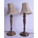 AN UNUSUAL PAIR OF 19TH CENTURY FRENCH BRONZE LAMPS modelled as double mask head females upon