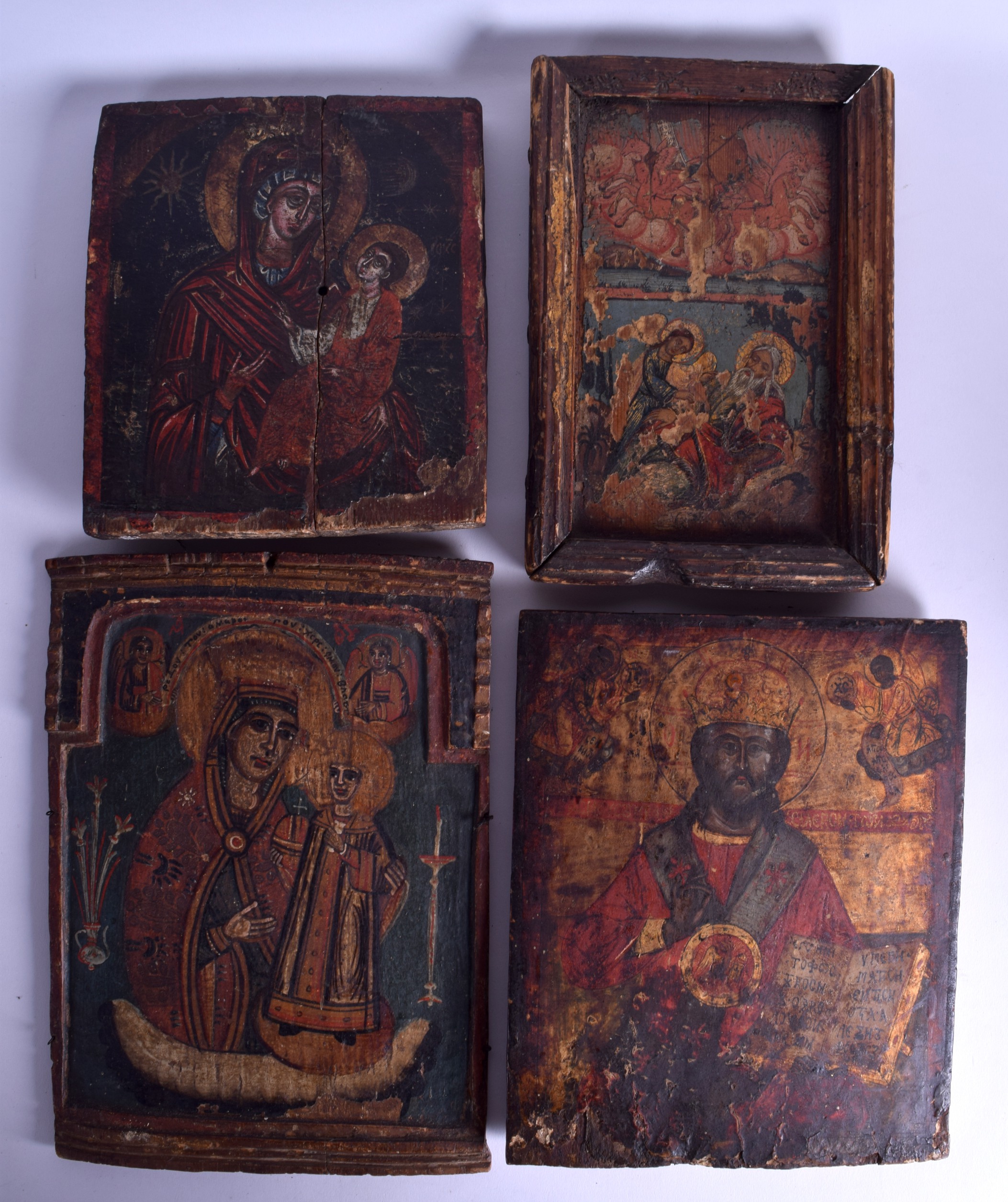 A GOOD GROUP OF FOUR 18TH/19TH CENTURY POLYCHROMED RUSSIAN ICONS painted with various scenes of