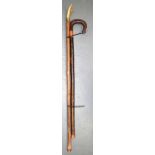 AN EARLY 20TH CENTURY STAFF, with bone terminal, together with a wooden walking stick. Longest 105