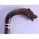 A GOOD 19TH CENTURY SOUTH EAST ASIAN CARVED HORN WALKING CANE in the form of a stylised dragon. 92