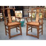 A PAIR OF EARLY 20TH CENTURY CHINESE CARVED ELM CHAIRS.