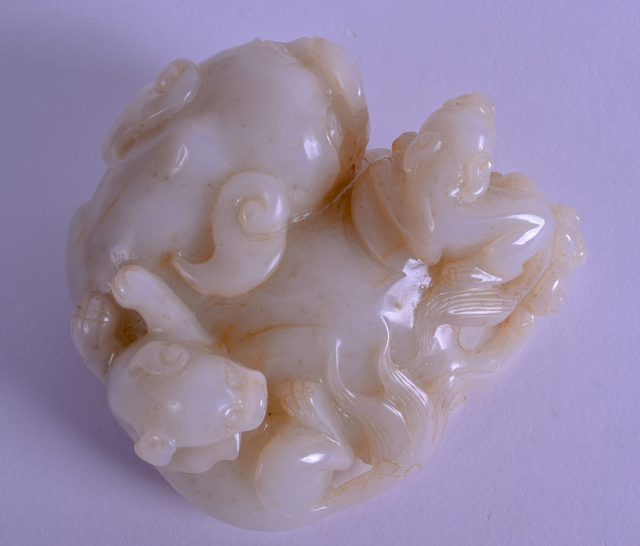 A 1950S CHINESE CARVED GREENISH WHITE JADE FIGURE OF A BUDDHISTIC LION modelled upon a - Bild 3 aus 4