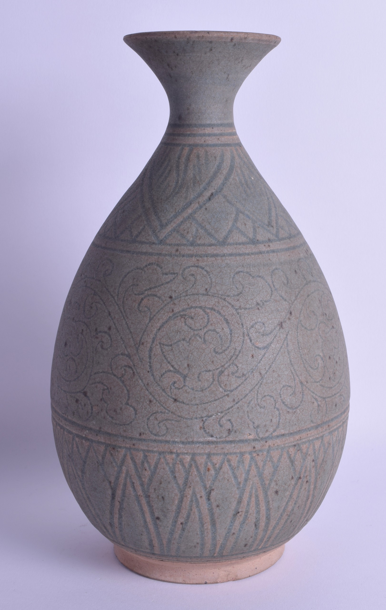 A CHINESE CHIZOU TYPE ENGRAVED POTTERY VASE possibly Ming, decorated with swirling floral vines