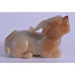 A 19TH CENTURY CHINESE CARVED GREEN RUSSET JADE FIGURE OF A BEAST modelled recumbent with incised