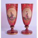 A PAIR OF 19TH CENTURY BOHEMIAN RUBY GLASS ENAMELLED VASES painted with young females standing
