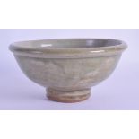 AN UNUSUAL CHINESE CELADON POTTERY BOWL possibly Ming, decorated in relief with animals and