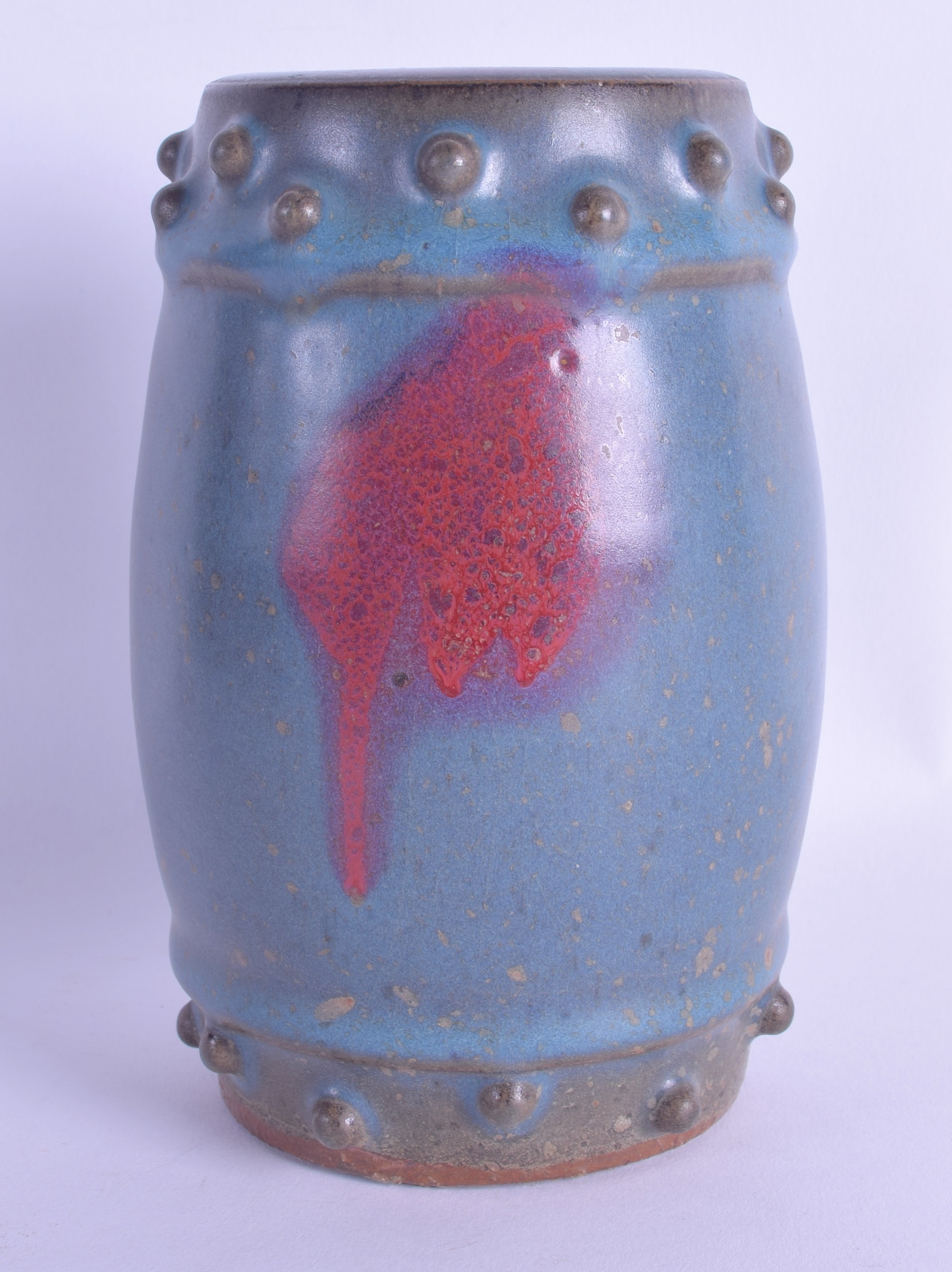 A CHINESE QING DYNASTY JUNYAO STONEWARE GLAZED POTTERY BARREL with purple splash decoration. 15 cm