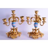 A GOOD PAIR OF 19TH CENTURY FRENCH SEVRES ORMOLU CANDLESTICKS painted with foliage, the bases