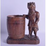 A RARE 19TH CENTURY BAVARIAN BLACK FOREST BRUSH POT modelled with a standing hound wearing a jacket.