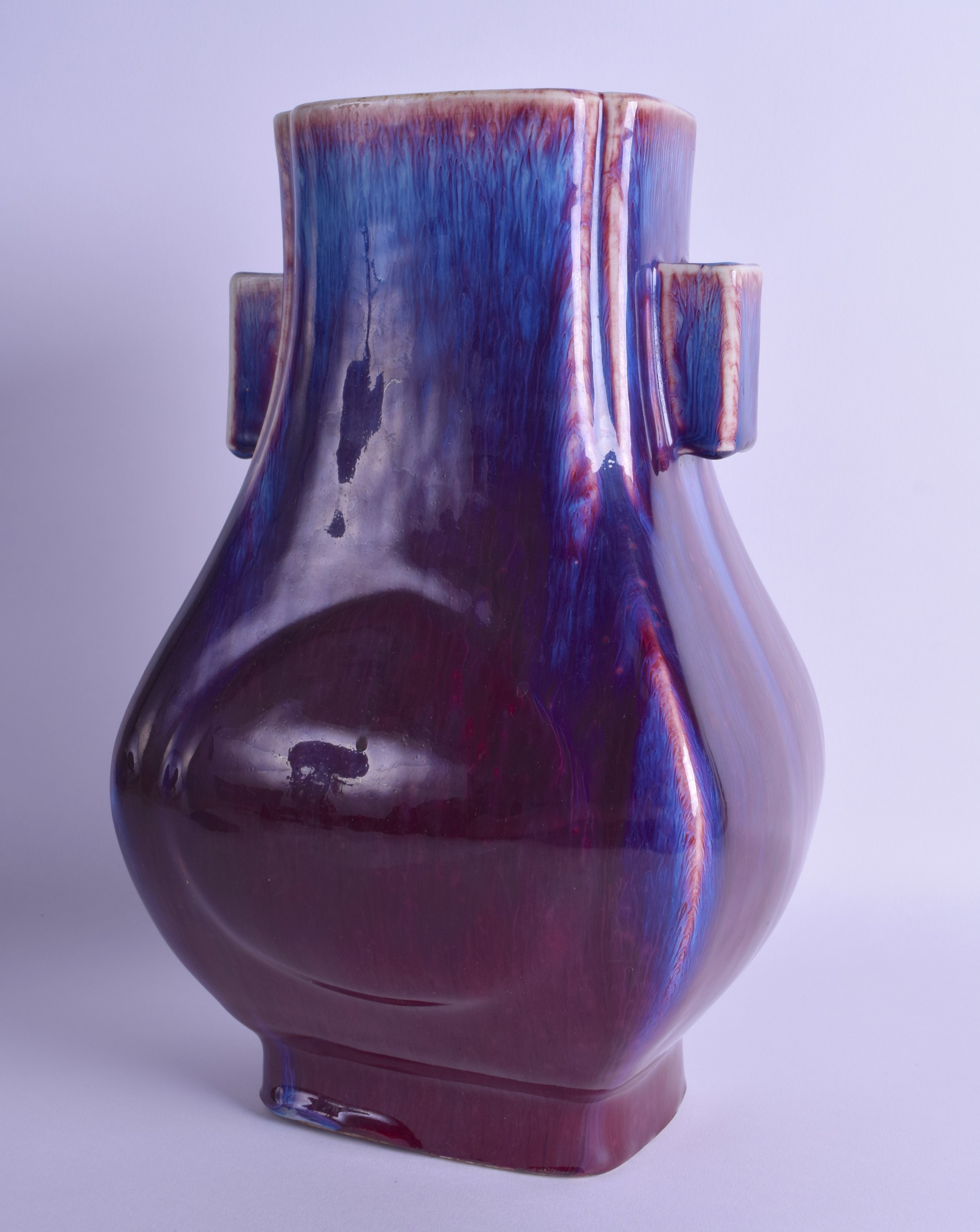 A 19TH CENTURY CHINESE FLAMBE GLAZED TWIN HANDLED HU FLASK bearing Qianlong marks to base, with drip