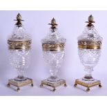A FINE SET OF THREE 19TH CENTURY FRENCH SILVER GILT AND CUT GLASS VASES AND COVERS with fruiting