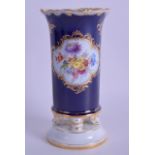 A LATE 19TH CENTURY MEISSEN PORCELAIN SPILL VASE painted with flowers upon a blue ground. 14 cm