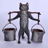 A COLD PAINTED BRONZE FIGURE OF A CAT modelled carrying milk churns. 10 cm high.