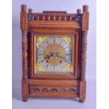 A LATE 19TH CENTURY CARVED OAK MANTEL CLOCK with columns supports and carved floral roundels. 40