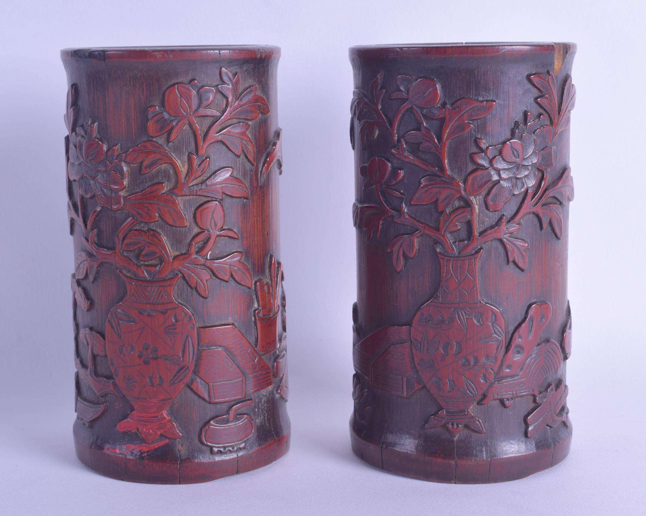 A PAIR OF CHINESE QING DYNASTY CARVED BAMBOO BRUSH POTS Bitong, decorated with urns and flowers.